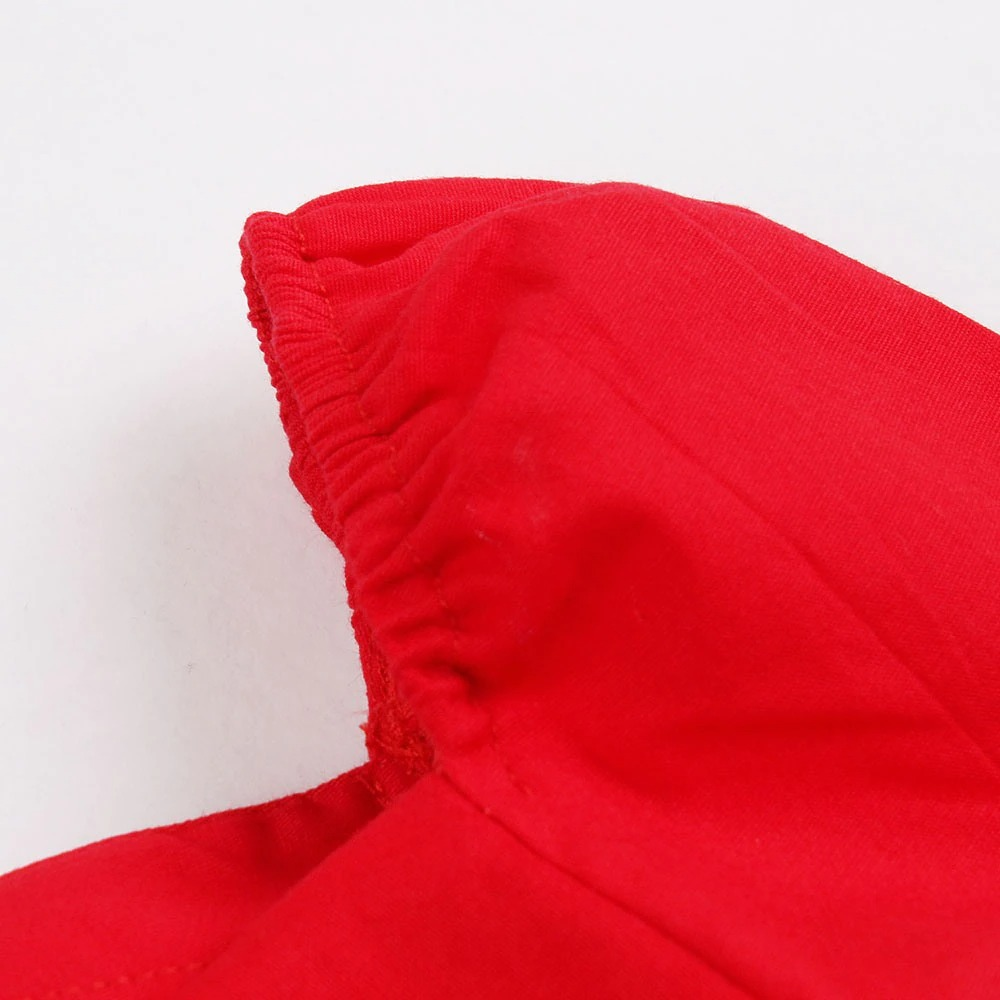 Close-up of the neckline detail on a vibrant red women's dress showcasing quality cotton fabric.