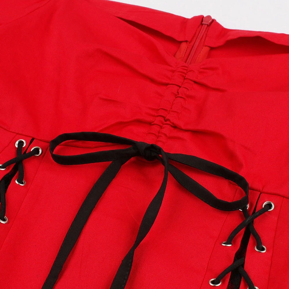 Close-up of red gothic lace-up dress featuring elegant black ribbon details and a stylish zipper.