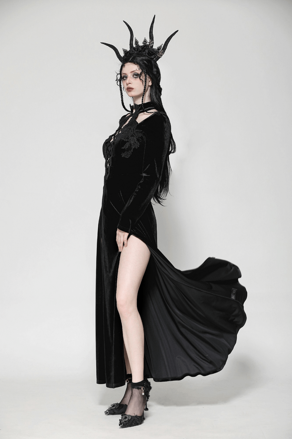 Gothic lace-up velvet dress with ruffled details and a dramatic slit, perfectly styled for a dark, edgy look.