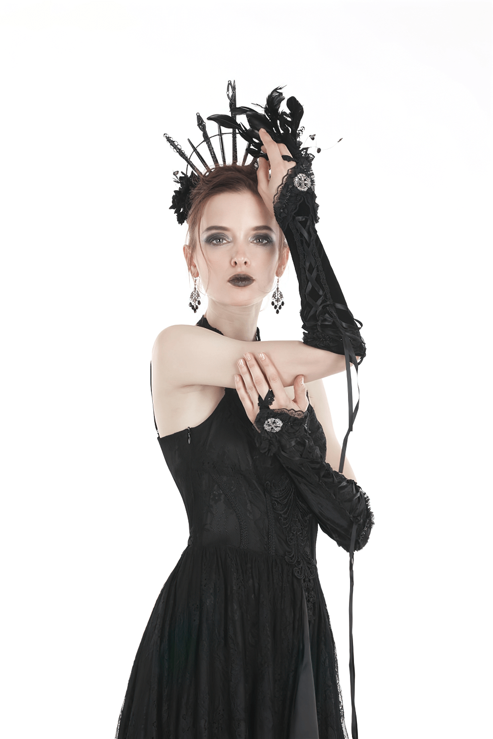 Woman in black gothic dress with lace gloves and ornate headpiece, showcasing Victorian elegance and dark romance.