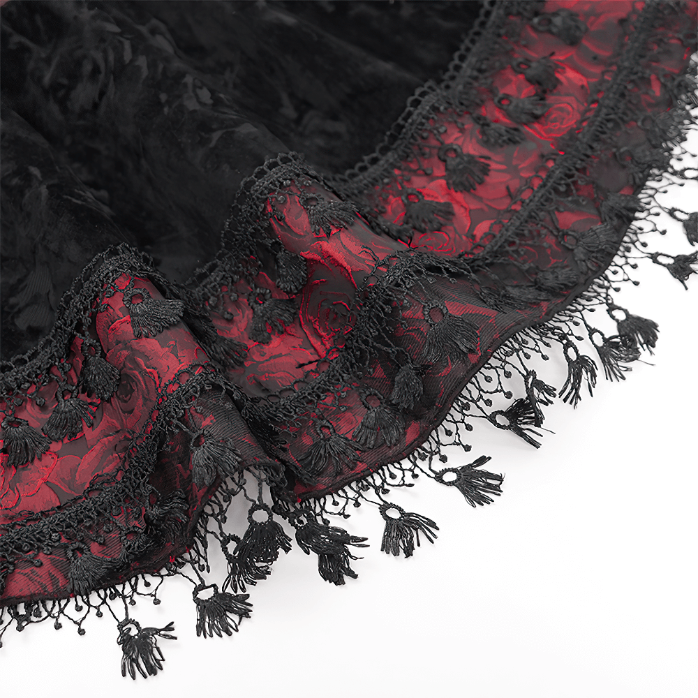 Close-up of Gothic lace-up velvet skirt featuring intricate black lace trim and red embroidered accents.