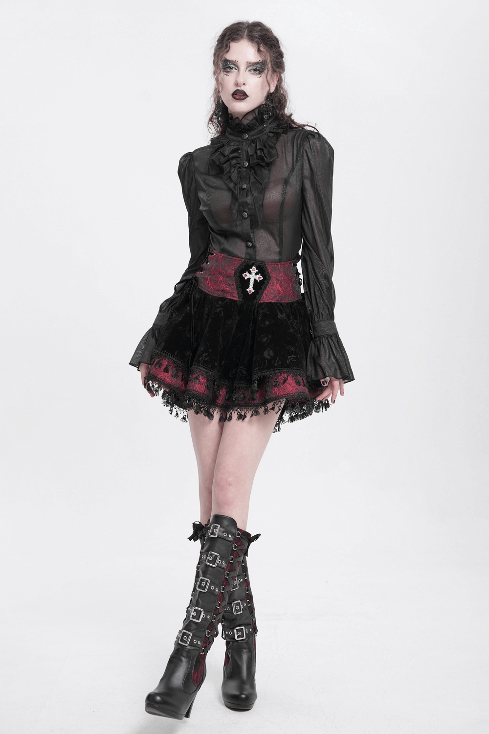 Model in a Victorian Gothic lace-up velvet skirt, featuring embroidered cross and lace details, paired with a ruffled blouse.