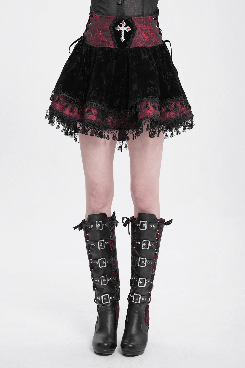 Gothic lace-up velvet skirt with embroidered cross, intricate lace trim, and stylish knee-high boots.