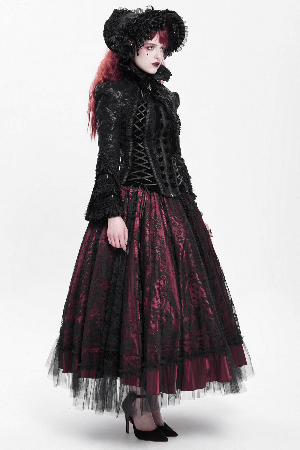 Gothic Lace-Up Victorian Jacket with Bell Sleeves and Cross styled with a dramatic black and red skirt.