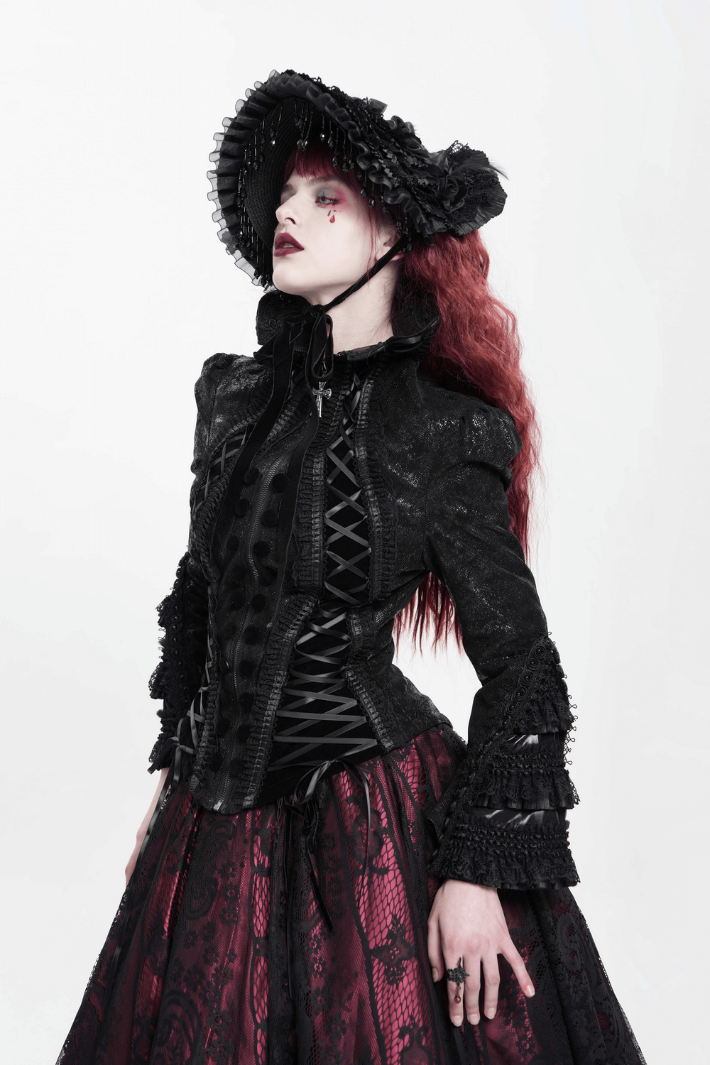 Gothic Lace-Up Victorian Jacket with Bell Sleeves and Cross worn by a model in a dramatic pose.