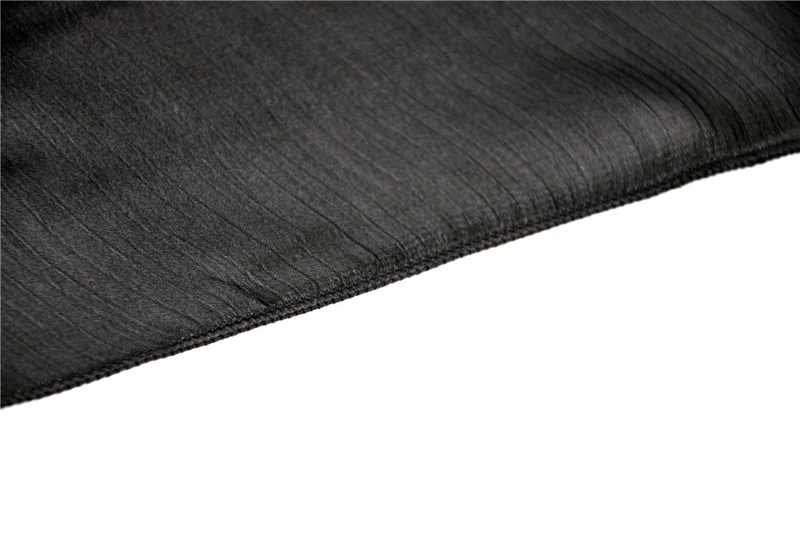 Close-up of luxurious black fabric showcasing a smooth texture, ideal for gothic fashion and modern styles.
