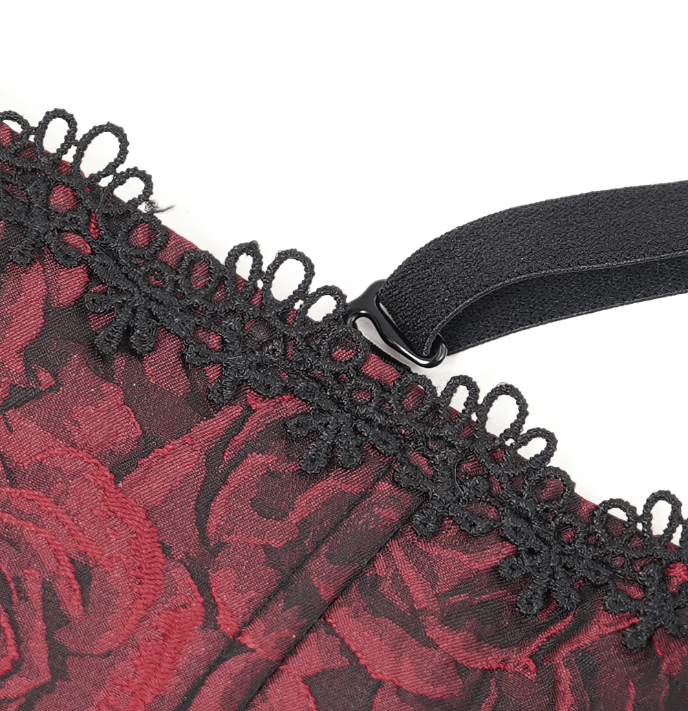 Close-up of gothic wine red corset lace trim and zipper detailing, showcasing floral patterns and ruffled edges.