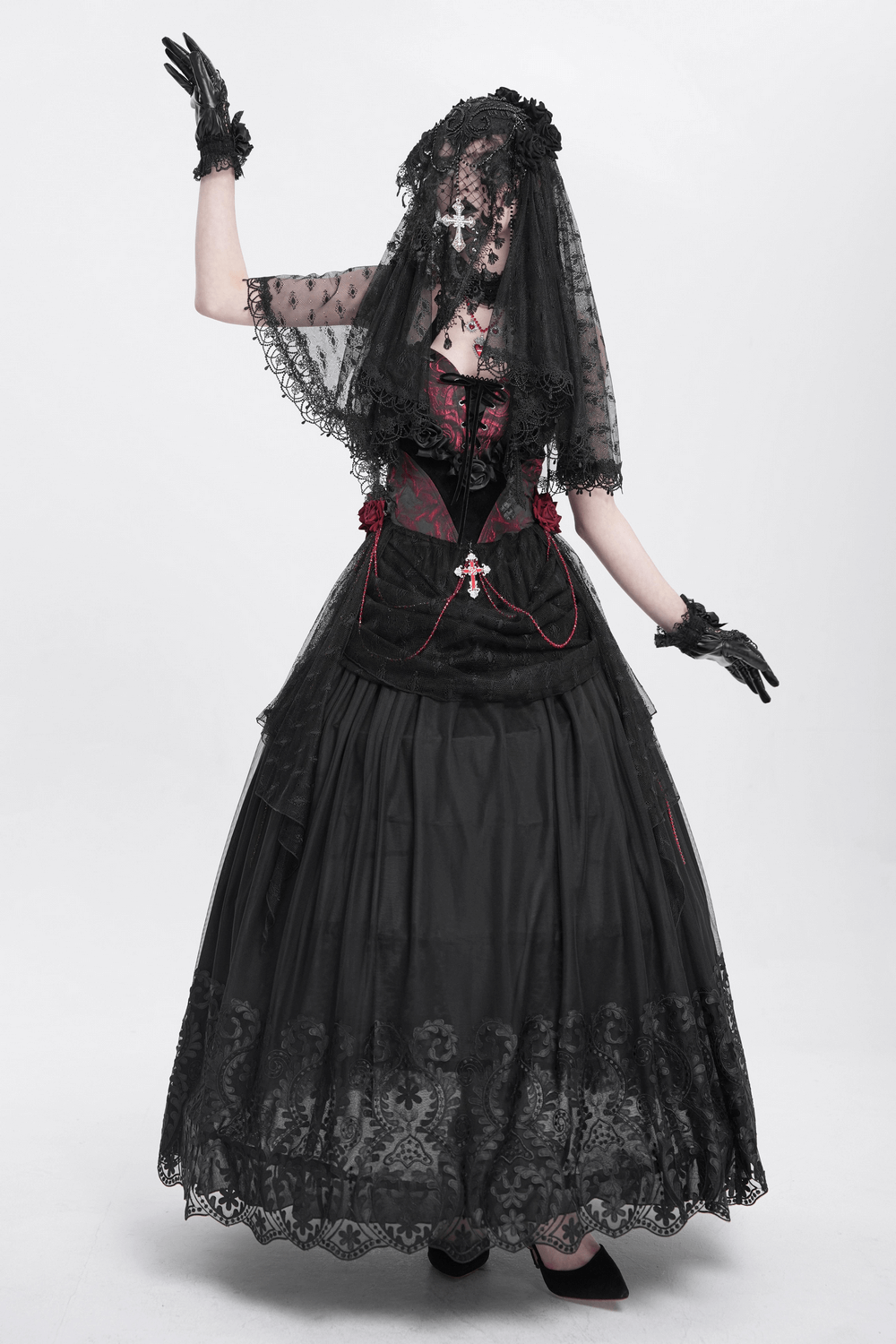 Elegant model in black gothic lace veil with floral details and cross pendant, showcasing vintage-inspired style.