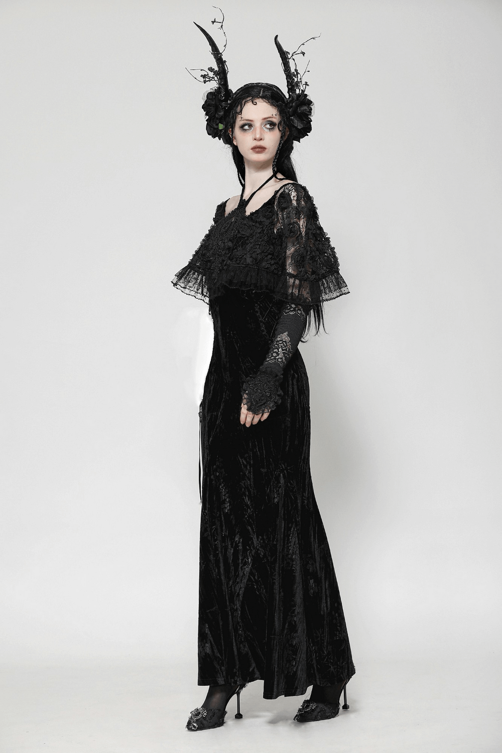 Elegant black gothic lace velvet maxi dress with ruffled hem, lace sleeves, and dark accessories, perfect for gothic events.