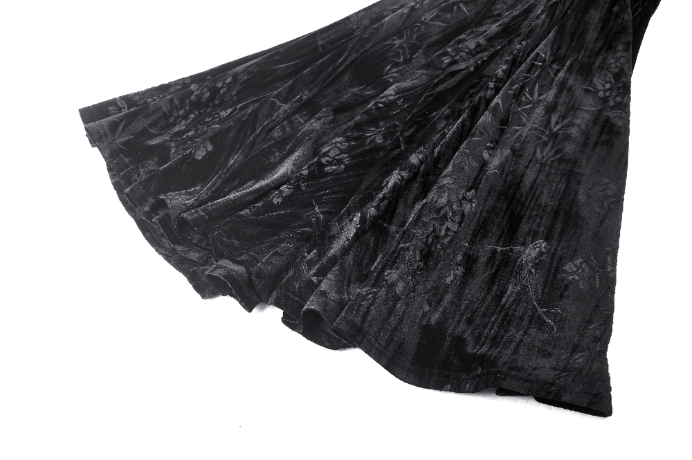 Elegant black velvet fabric with intricate floral patterns, perfect for a gothic maxi dress with ruffled hem.