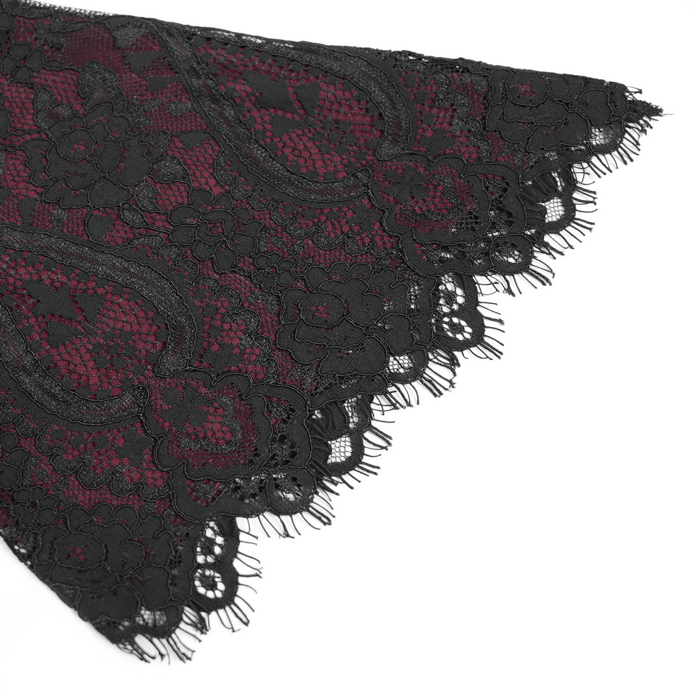 Close-up of gothic lace featuring intricate black floral designs over wine red fabric, perfect for a romantic look.