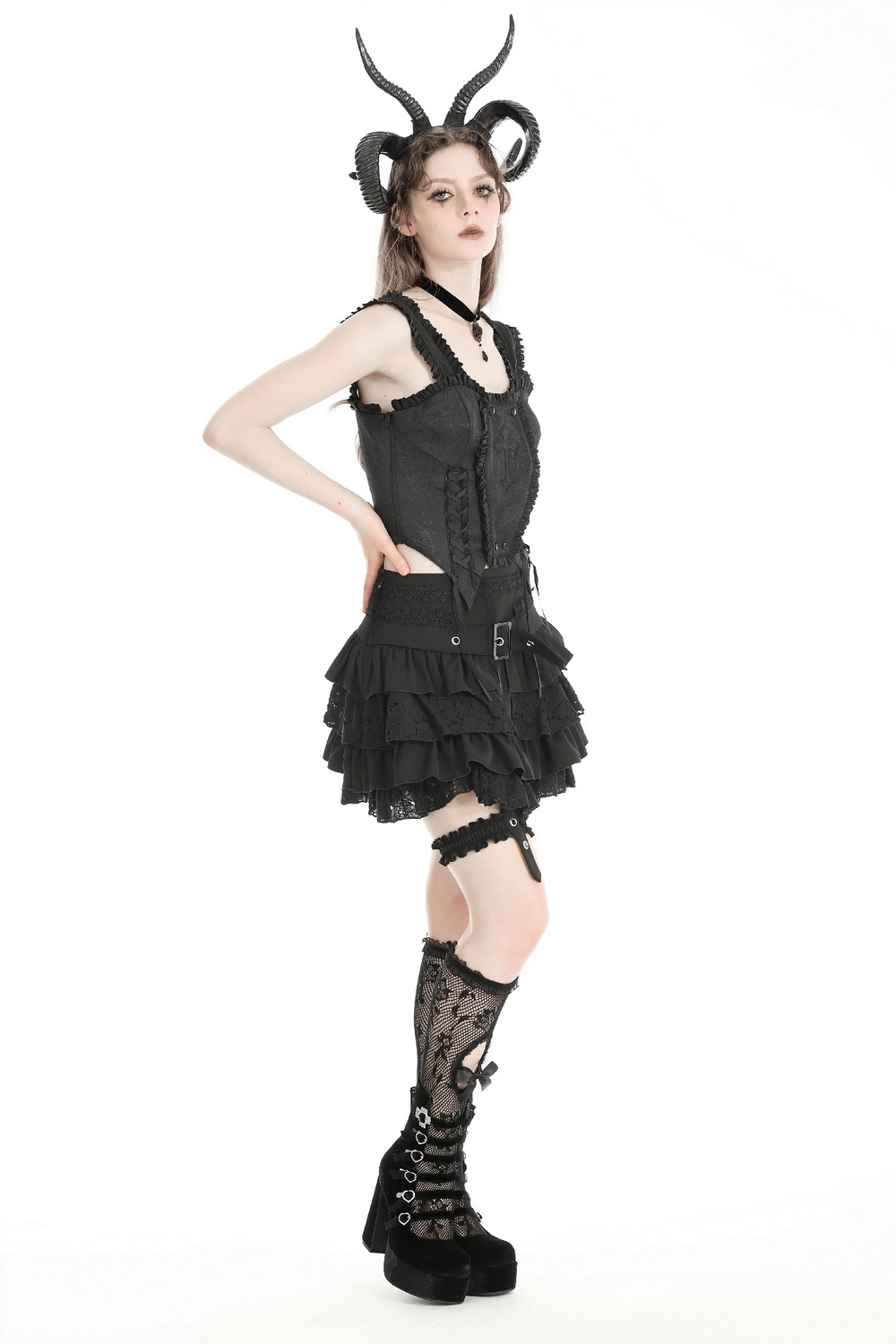 Model showcasing a gothic layered ruffle mini skirt with lace details, garters, and stylish heels.