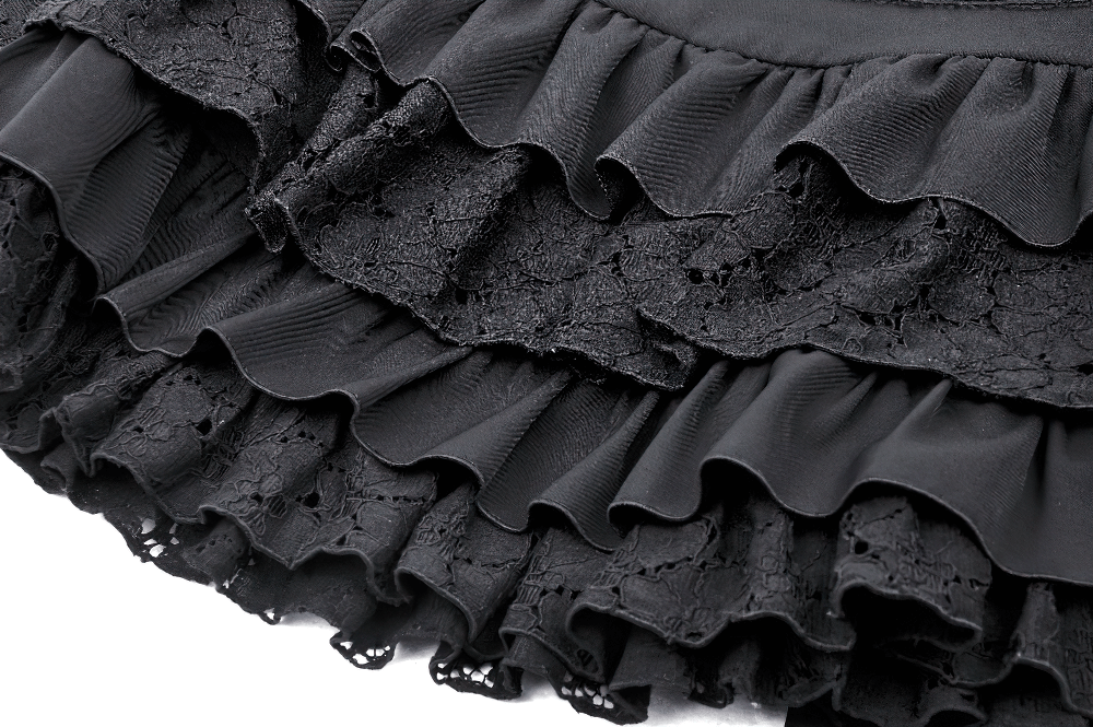 Close-up of a black gothic ruffle mini skirt featuring layered lace details and elegant ruffles, perfect for edgy fashion looks.