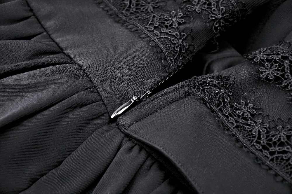 Close-up of black gothic skirt zipper with intricate lace detailing, showcasing ruffles and elegant craftsmanship.