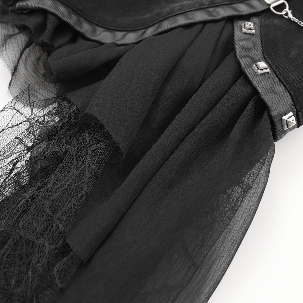 Close-up of gothic layered shorts featuring tulle, lace trim, and decorative chain accents for a punk-inspired look.