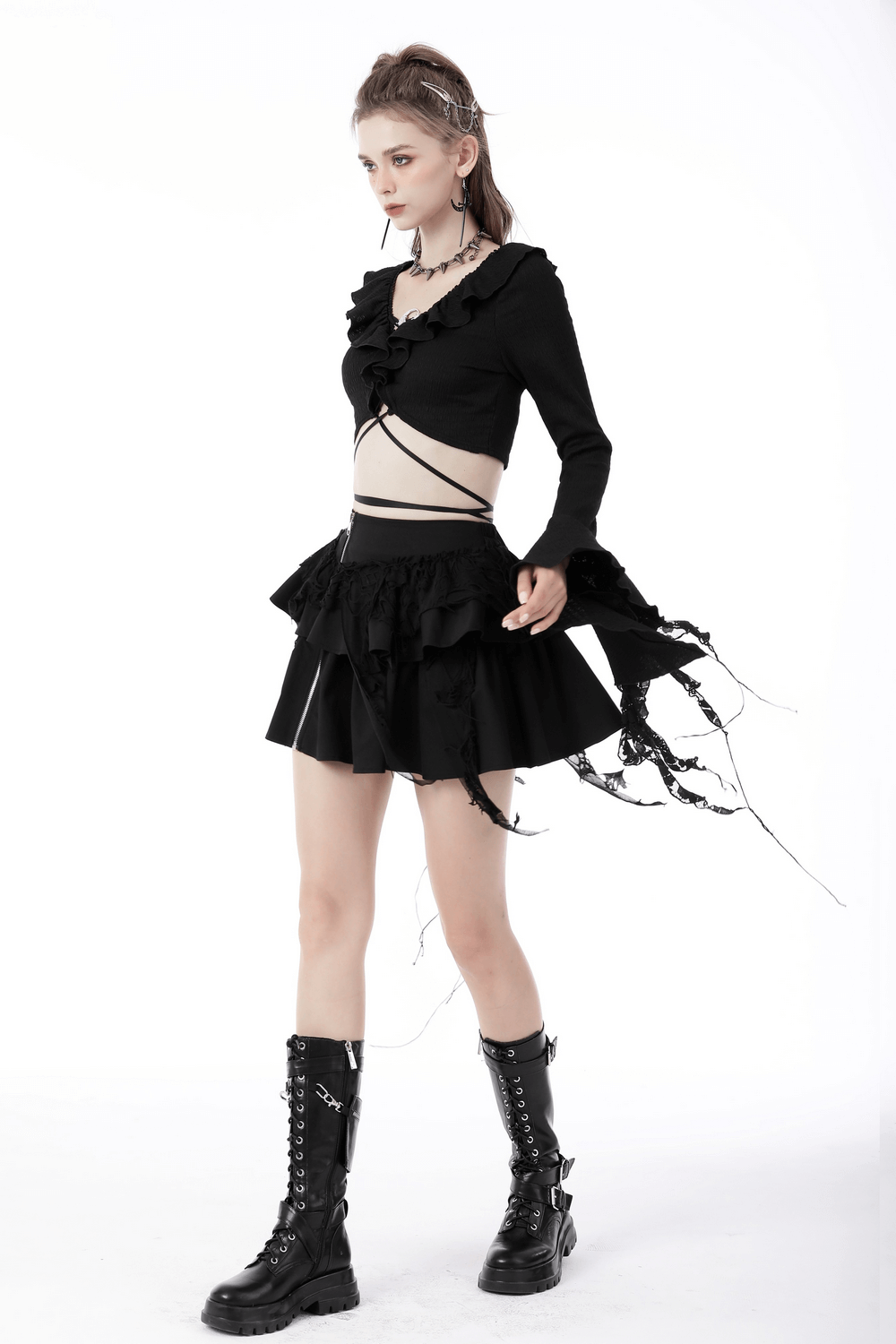 Gothic layered mini skirt with ruffles and zipper accent, paired with a stylish top and edgy boots for alternative fashion.