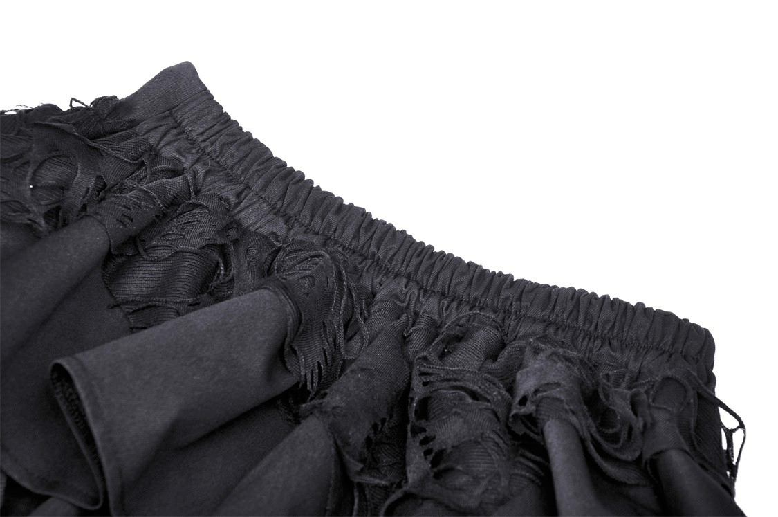 Close-up of the waistband and layered ruffles of a Gothic skirt with elastic detailing and edgy texture.