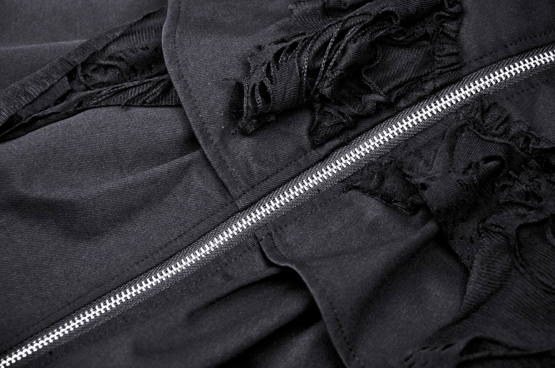 Gothic skirt close-up featuring ruffle details and edgy silver zipper accent on layered black fabric.
