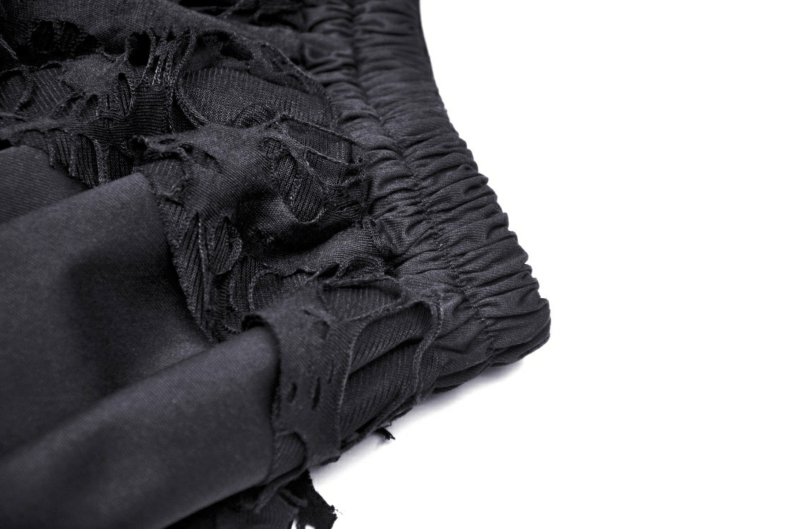 Close-up of black Gothic skirt fabric with lace, ruffles, and smocked waist for edgy alternative fashion.