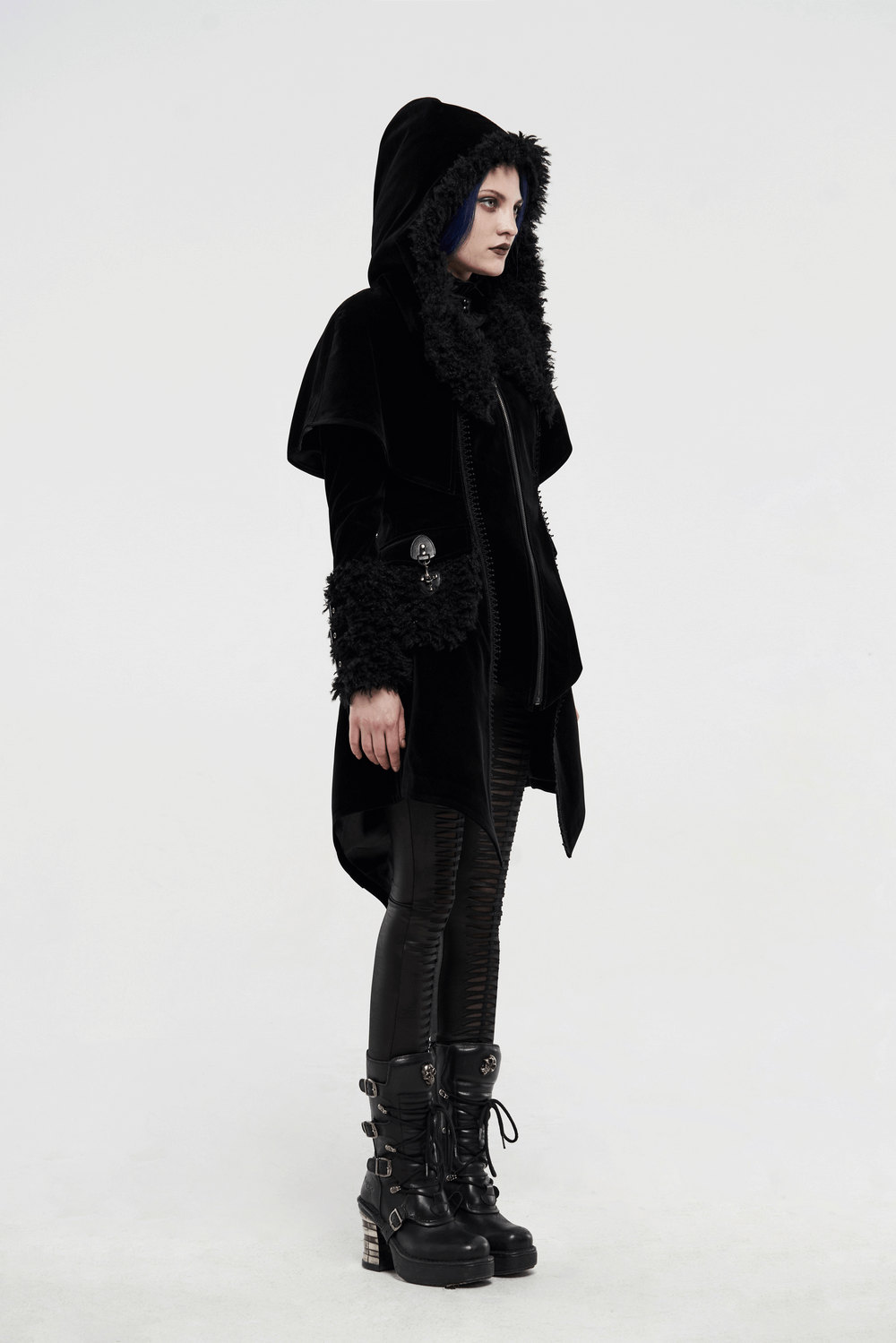 Gothic layered velvet cloak with faux fur trim, stylishly worn with edgy black pants and boots.