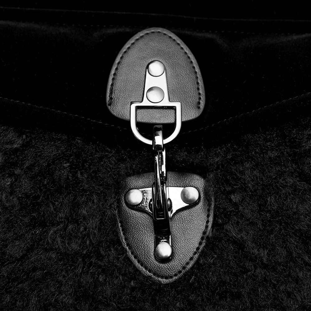 Close-up of the gunmetal-colored buckle and clasp on a Gothic velvet cloak with faux fur trim.