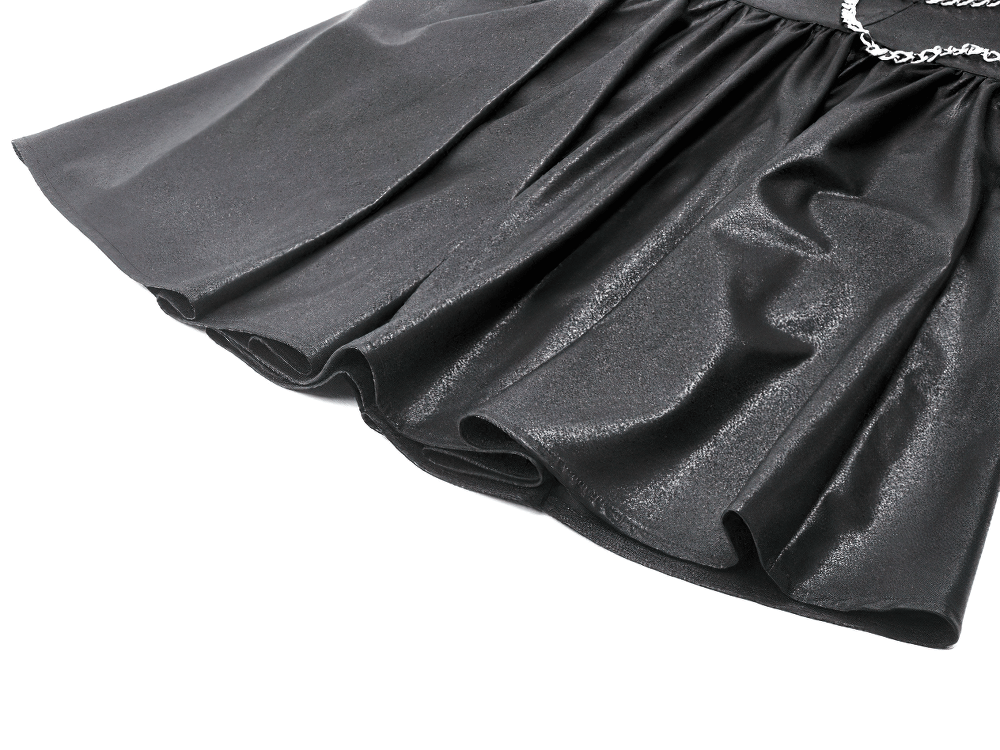 Close-up of the flared skirt of a gothic leather dress with shiny texture and dramatic ruffled edges.