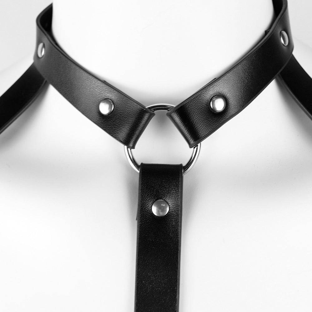 Close-up of a gothic leather lingerie harness for women featuring metal rings and studs, perfect for sexy apparel.