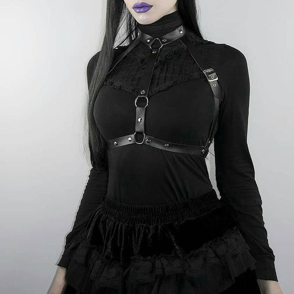 Gothic leather lingerie harness on woman in a black outfit, stylish and sexy accessory for bondage enthusiasts.