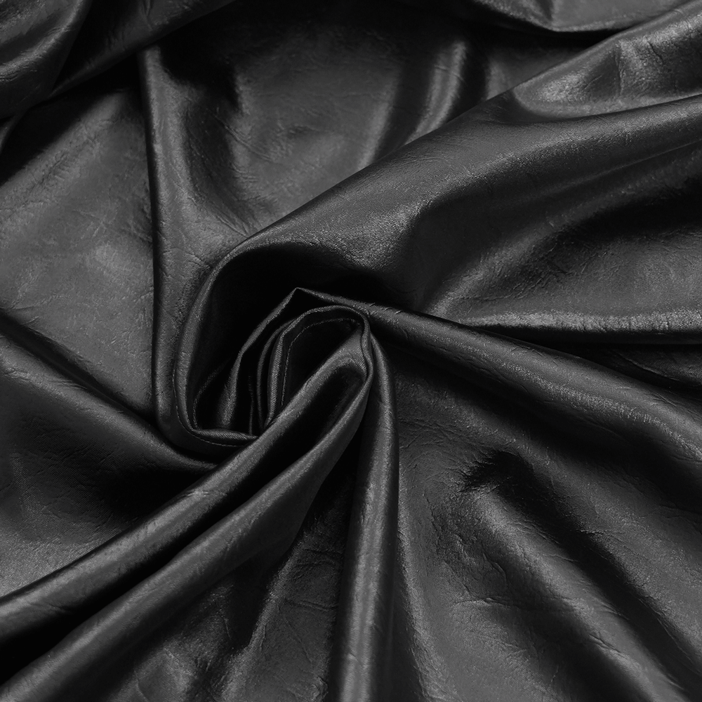 Close-up of black leather fabric, showcasing its luxurious texture and sheen for Gothic fashion.