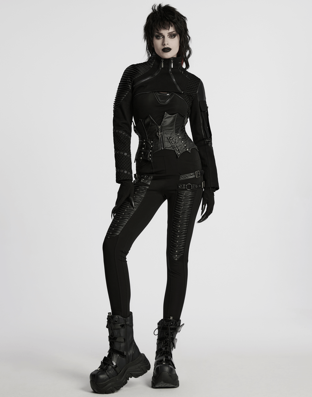 Gothic leather waist corset with zipper and lace-up back, styled with edgy black attire and combat boots.