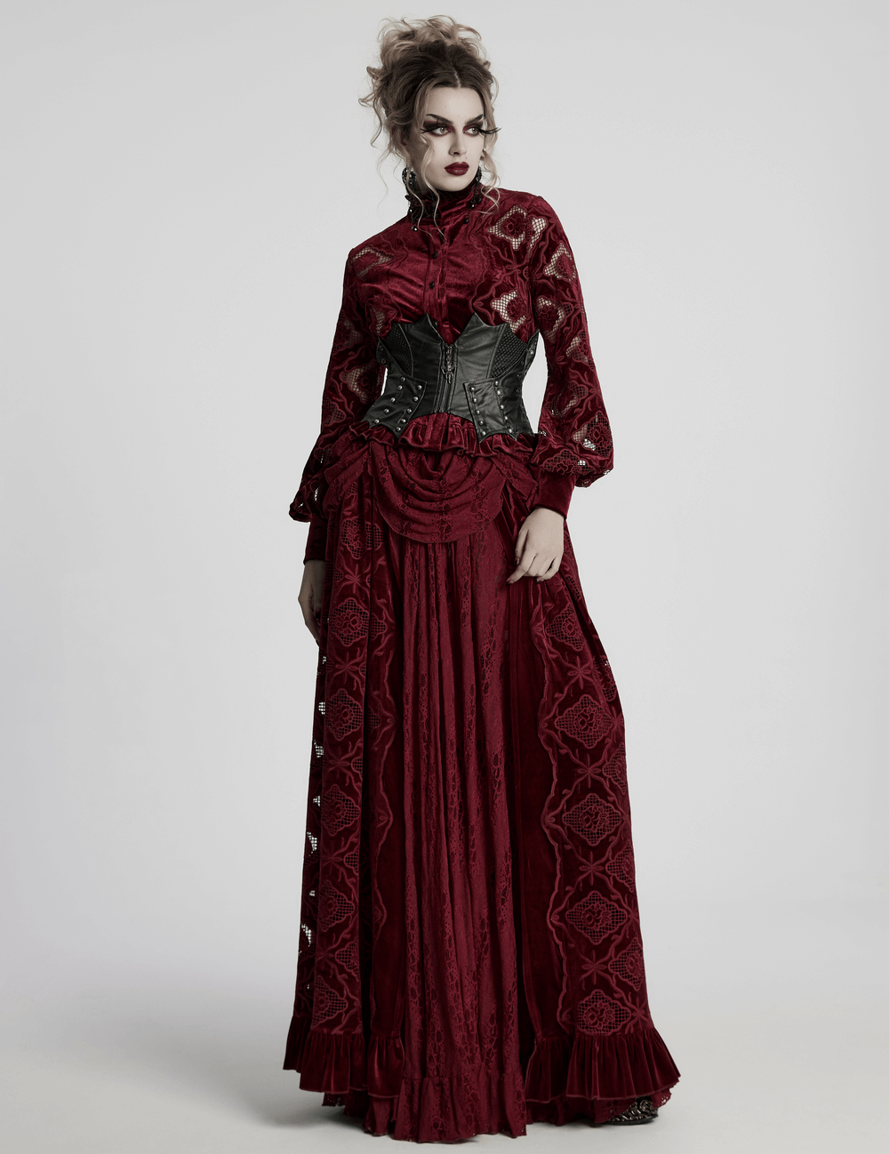 Gothic model wearing a red Victorian dress with a leather corset, showcasing elegant lace and dramatic sleeves.