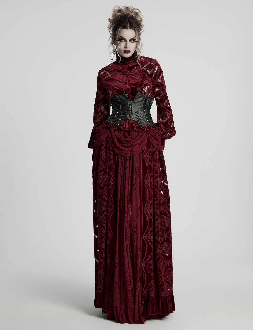 Gothic woman in a burgundy dress with a black leather waist corset, featuring lace and elegant details.