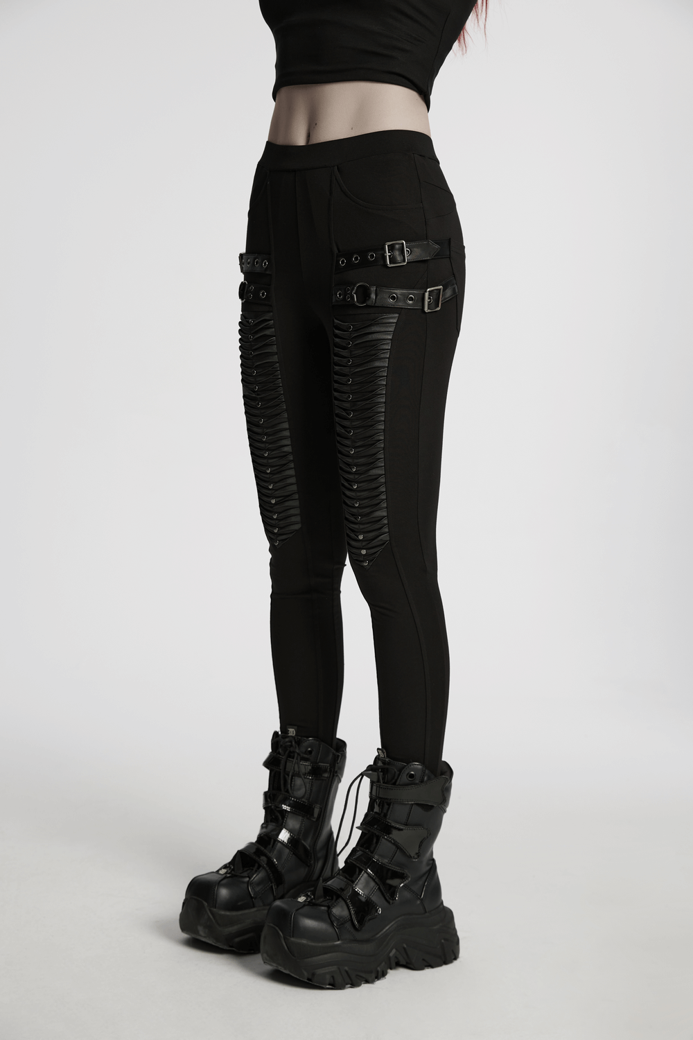 Gothic leggings featuring stylish 3D pleats and edgy faux leather straps, perfect for a bold look.