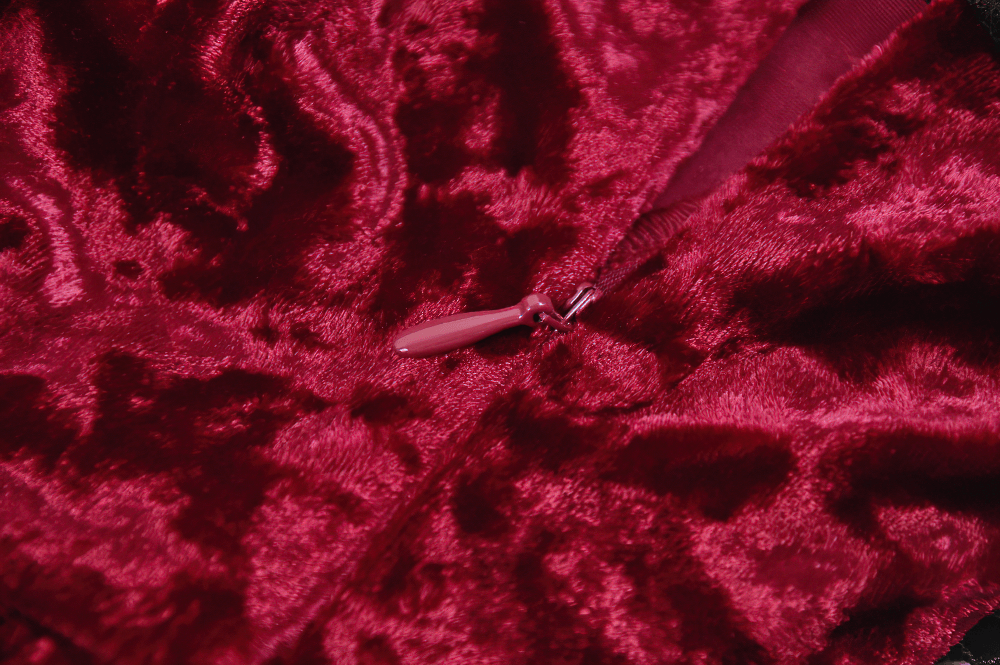 Close-up of the luxurious crushed velvet of the Gothic Lolita Mini Dress with Black Lace Details, showcasing rich burgundy texture.