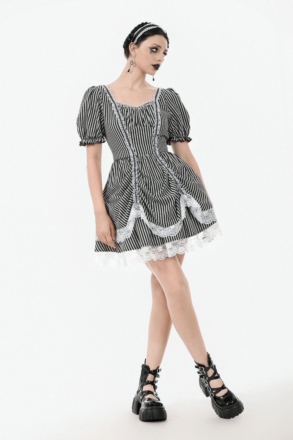 Gothic Lolita dress with puff sleeves, black and white stripes, lace trim, and bow, perfect for vintage fashion lovers.