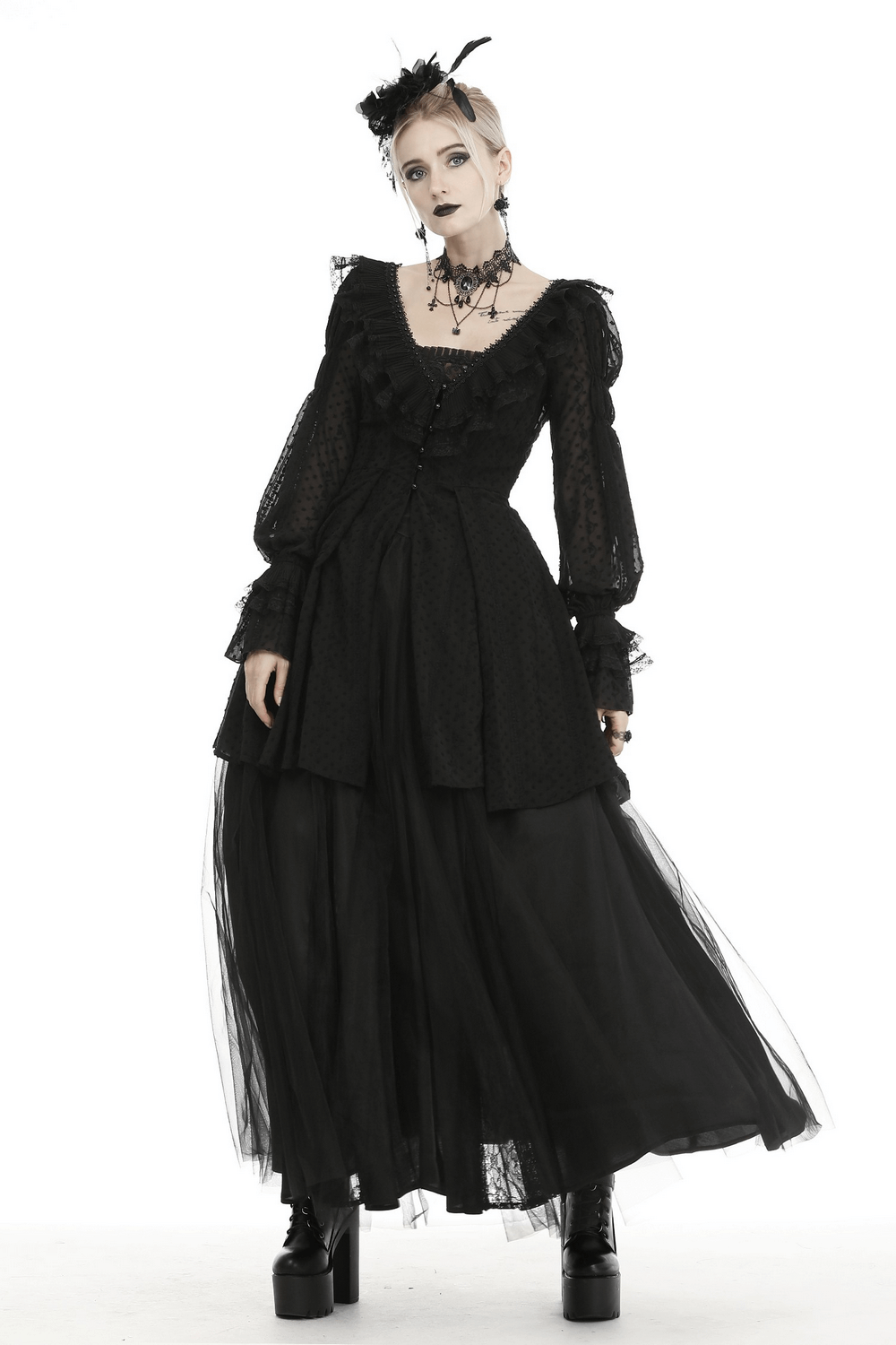 Gothic Lolita model in dramatic black coat with ruffles and long sleeves, showcasing edgy yet elegant fashion.