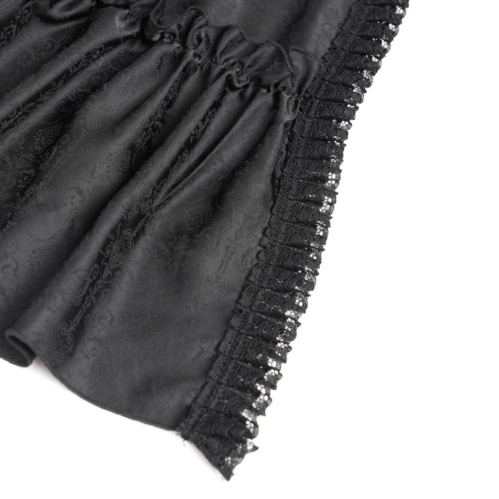 Close-up of black fabric with elegant lace trim, showcasing the detailed design of a Gothic dress.