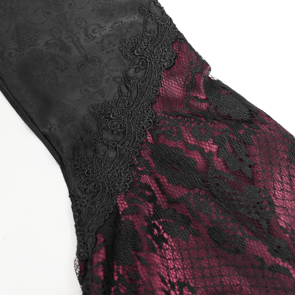 Close-up of gothic black and wine red lace detailing on a medieval-style dress, showcasing intricate textures.
