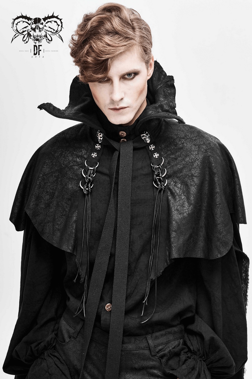 Male model wearing a gothic long black cloak with a stand-up collar, embellished with decorative tassels.