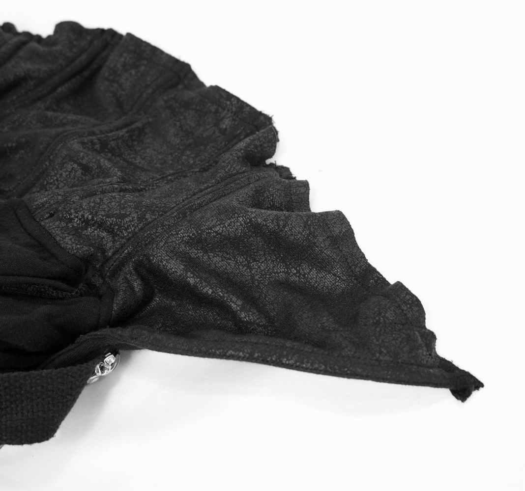 Close-up of the intricate fabric texture and ruffled edges of a black gothic cloak.