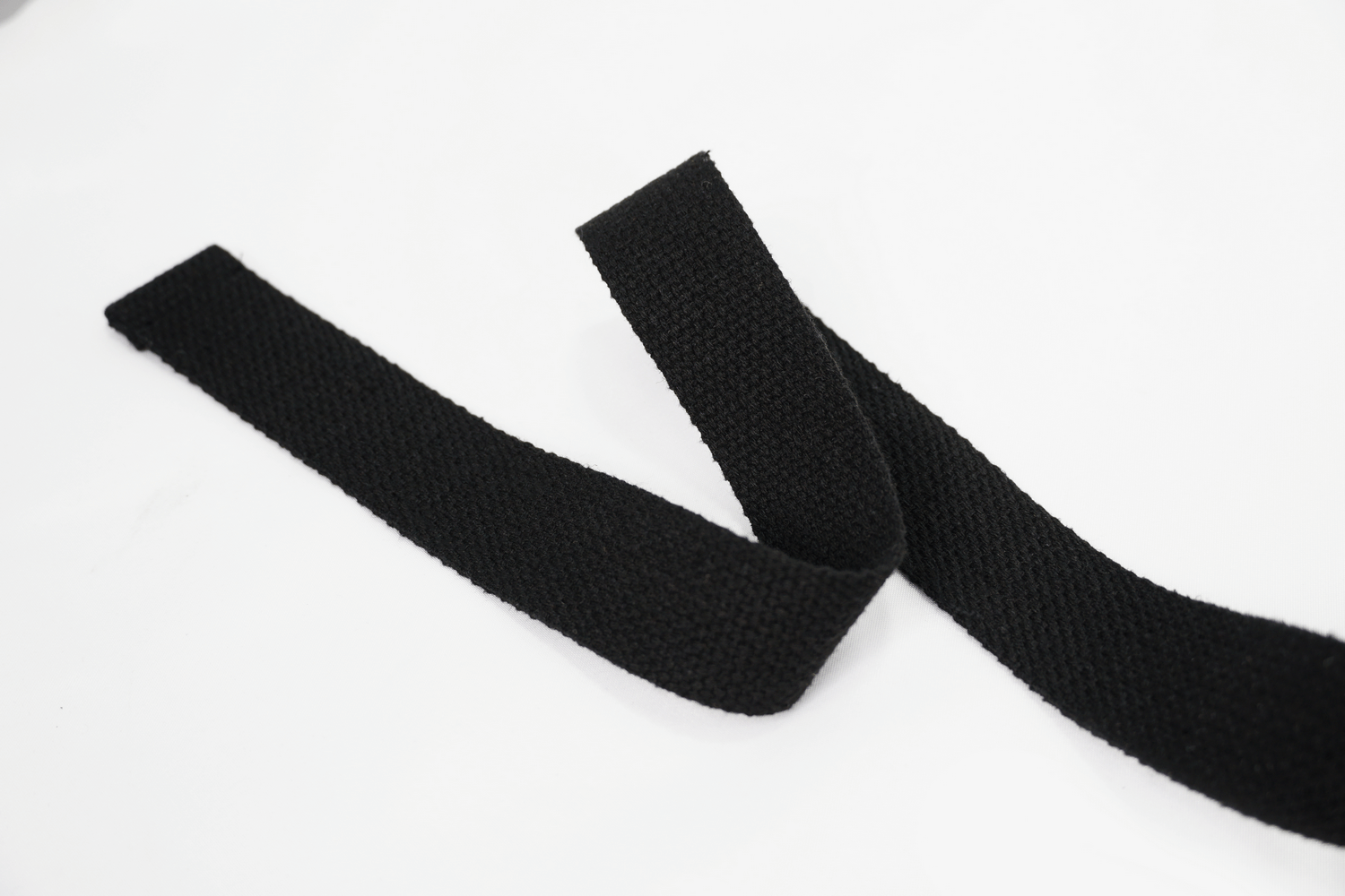 Two black woven straps laid out on a white background, perfect for various crafting and sewing projects.