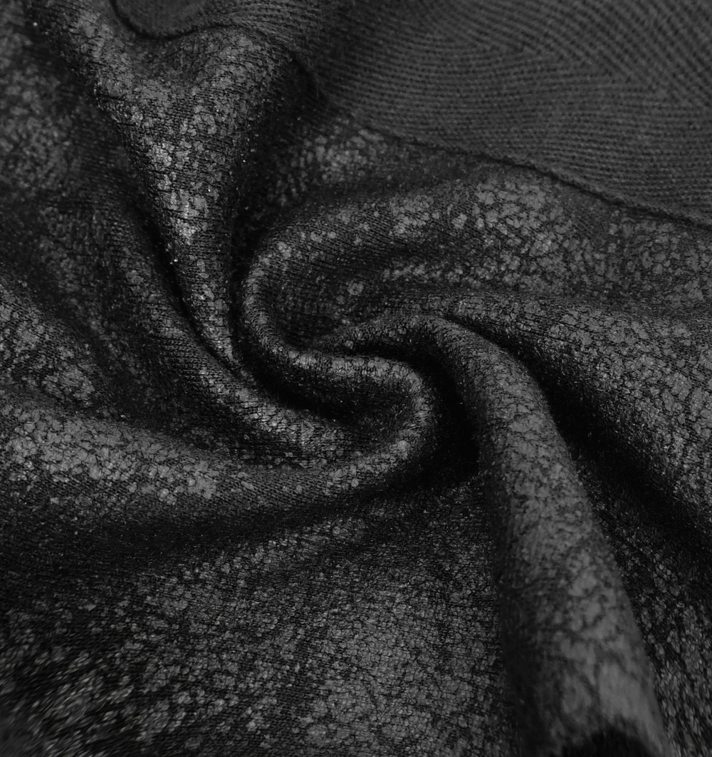 Close-up of black fabric with a textured finish, perfect for a gothic cloak or dramatic evening wear.