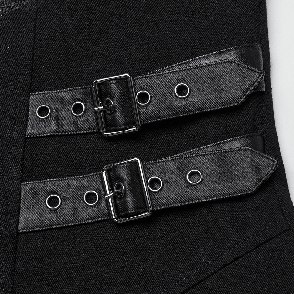 Close-up of X-shaped buckles and straps on a gothic long coat, showcasing punk style and layered design.