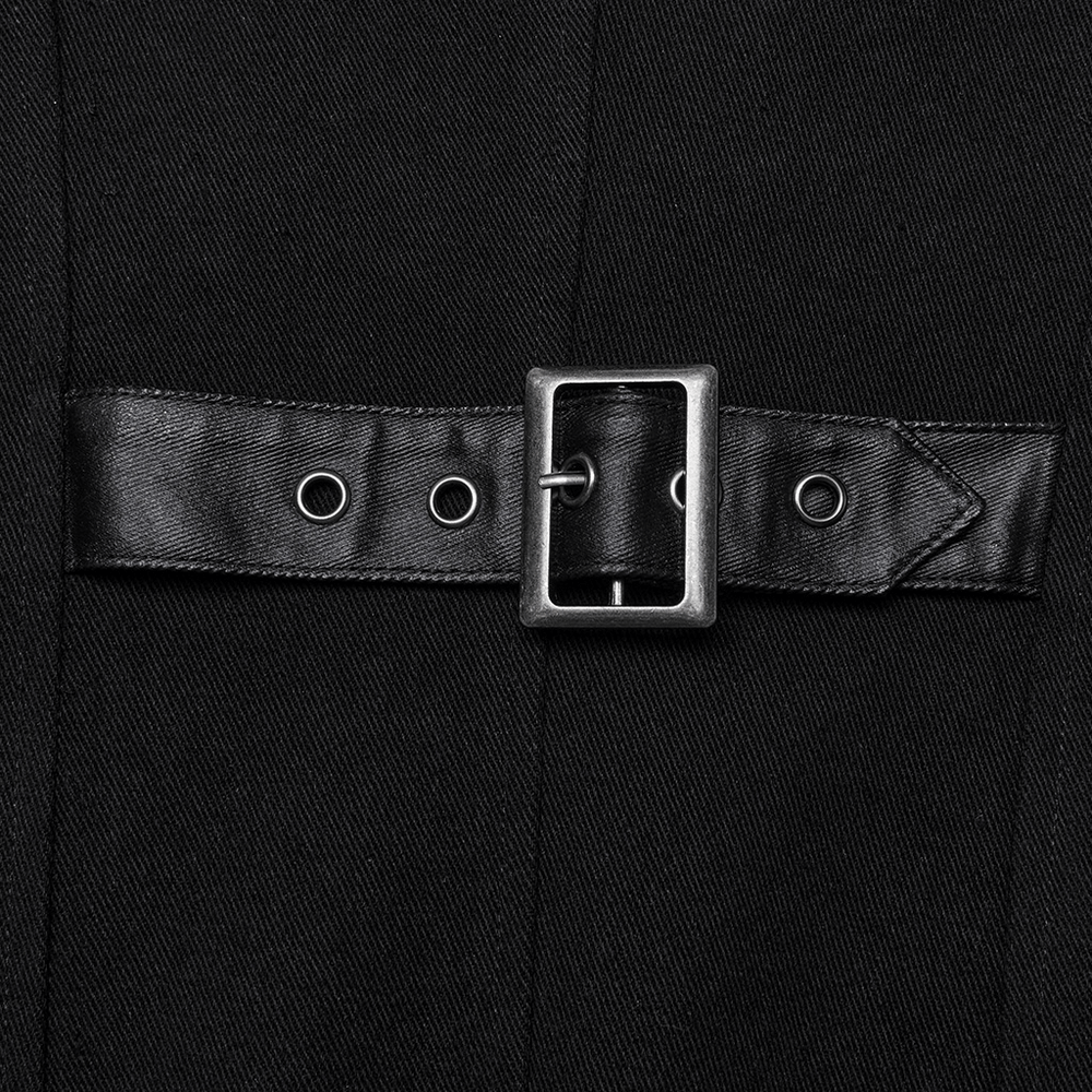 Close-up of X-buckle detail on gothic long coat, showcasing sleek black fabric and silver hardware accents.