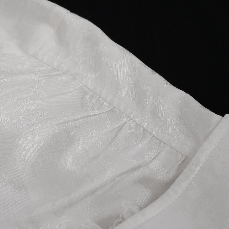 Close-up of elegant white jacquard fabric with pleating and lace detail for gothic long sleeve shirt.