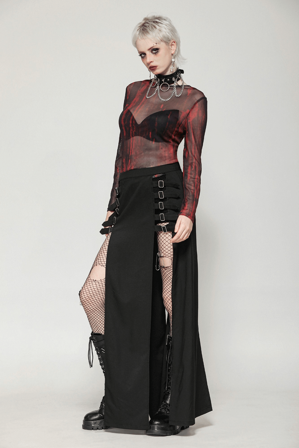 Gothic long skirt with side cutouts and buckle straps, styled with a sheer top and edgy accessories.