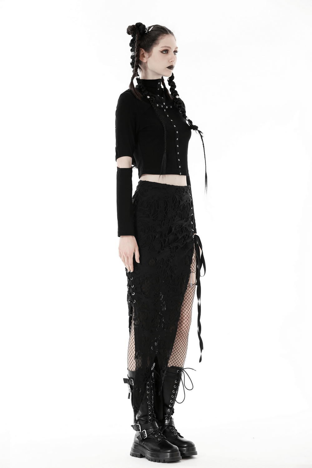 Gothic model wearing black crop top with eyelets and hood, paired with stylish lace skirt and combat boots.