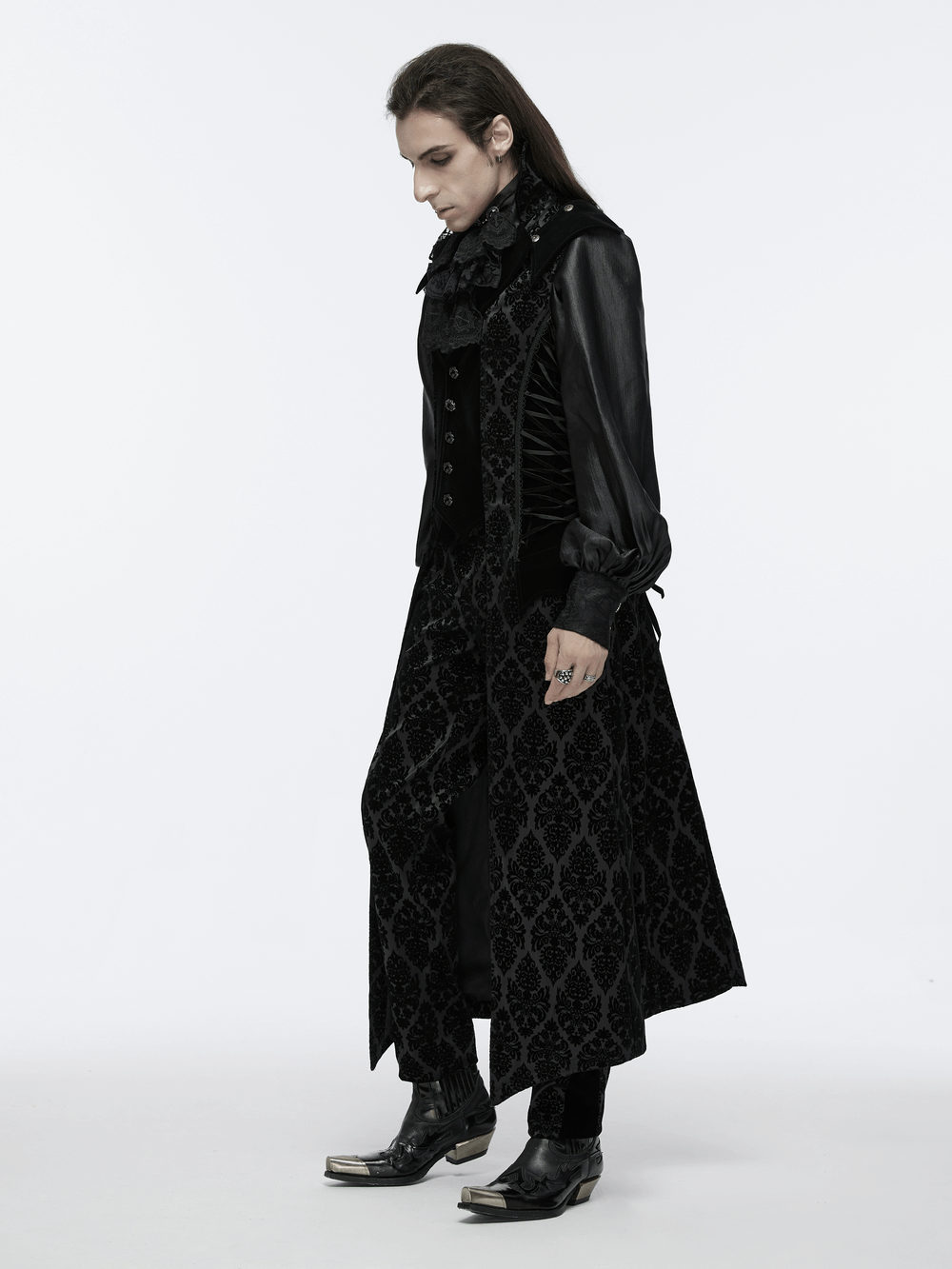 Gothic long waistcoat with stand collar, velveteen details, and detachable panels worn by model in sleek black outfit.