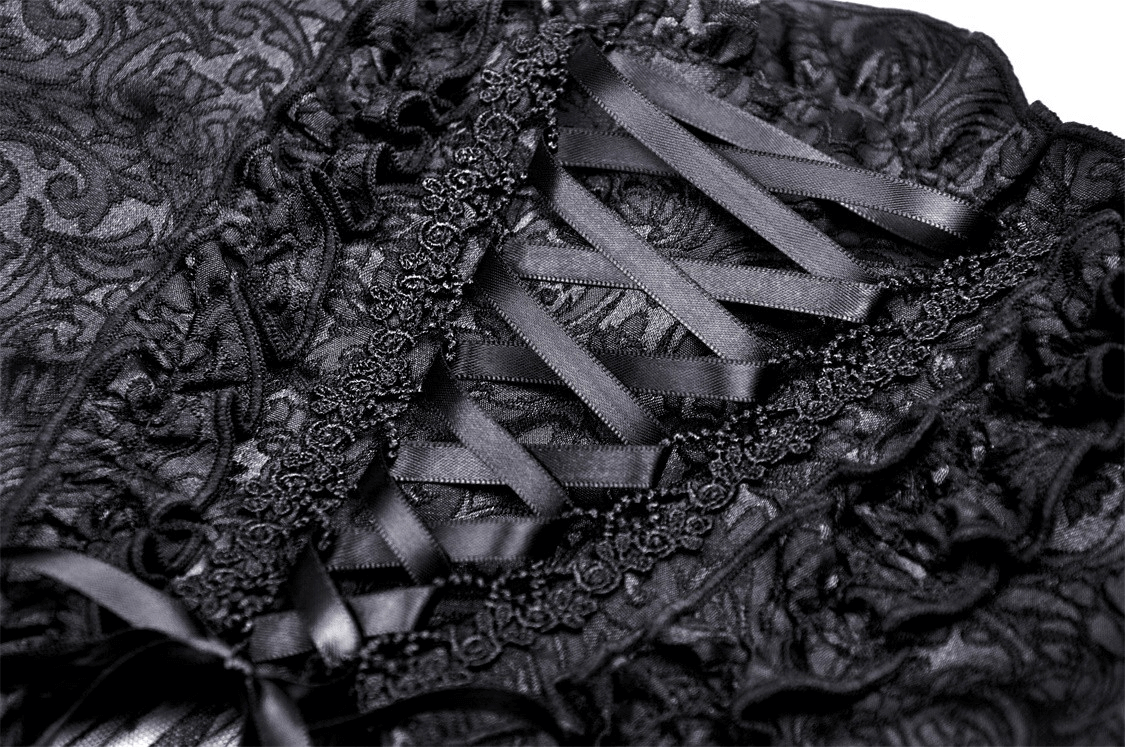 Intricate lace detailing and corset lacing of a gothic black skirt, showcasing elegant black fabric and textures.