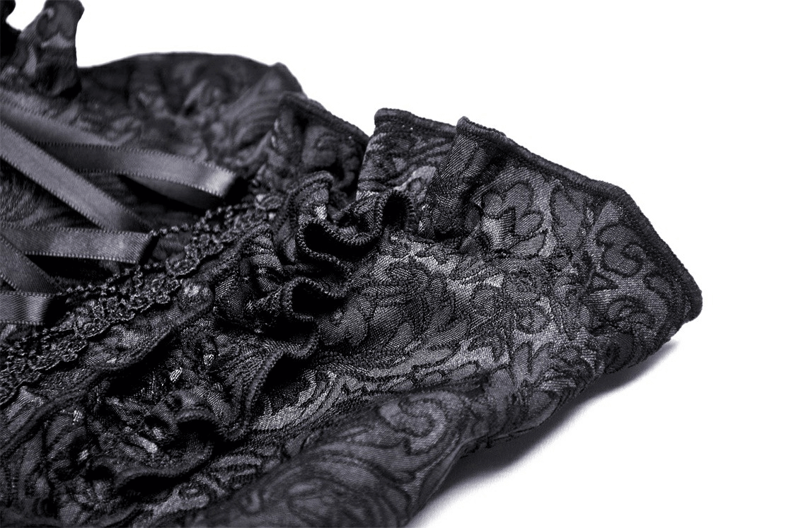 Close-up of intricate black lace detailing on gothic corset skirt for women.